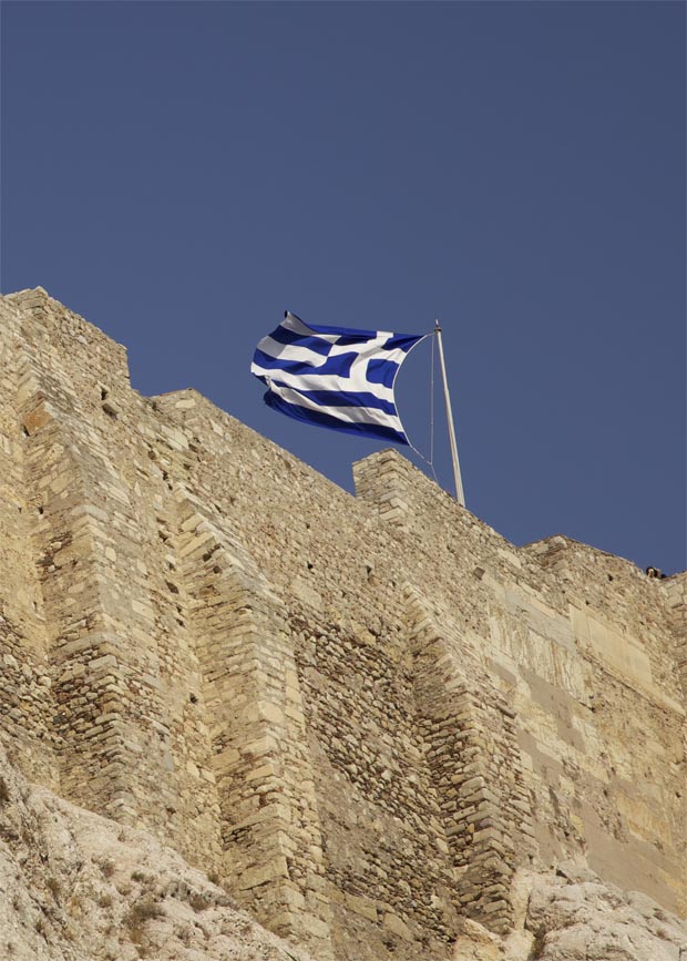 Greek flag on the walls of the Acropolis in Athens
