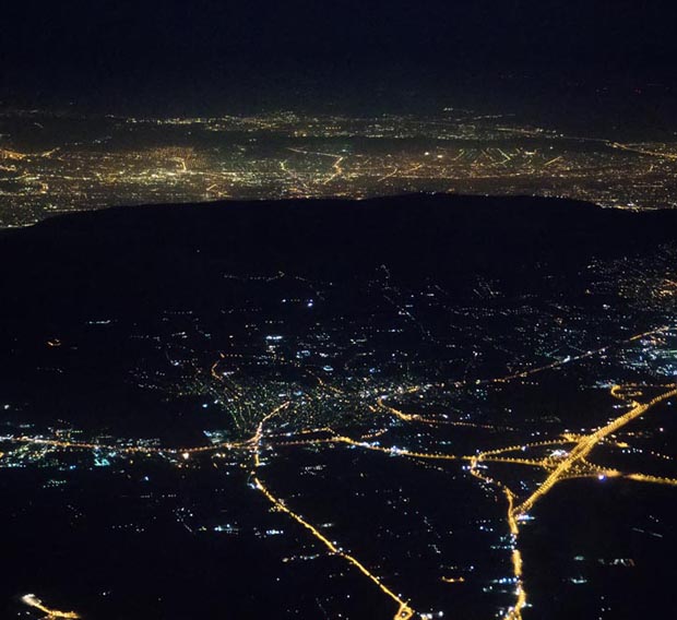 At night over Athens Greece with the dark silouhette of Ymittos in view - click to enlarge and expand the photo At night over Athens Greece with the dark silouhette of Ymittos in view
