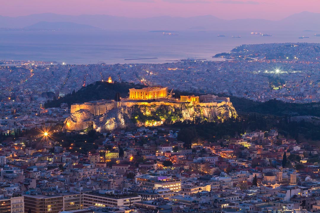 Dusk colors over the Acropolis and Parthenon with Piraeus in the distance Dusk colors over the Acropolis and Parthenon with Piraeus in the distance